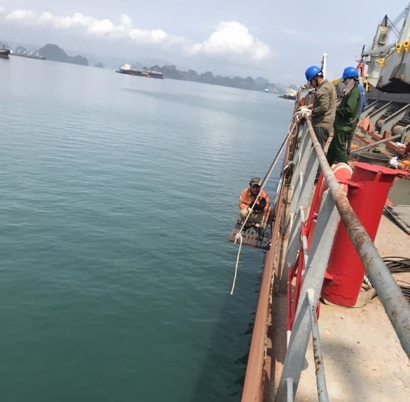 Repair crew at the ship side rail