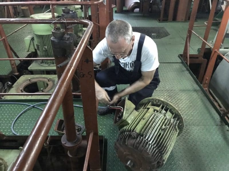 Technician disconnecting an electric motor for rewinding