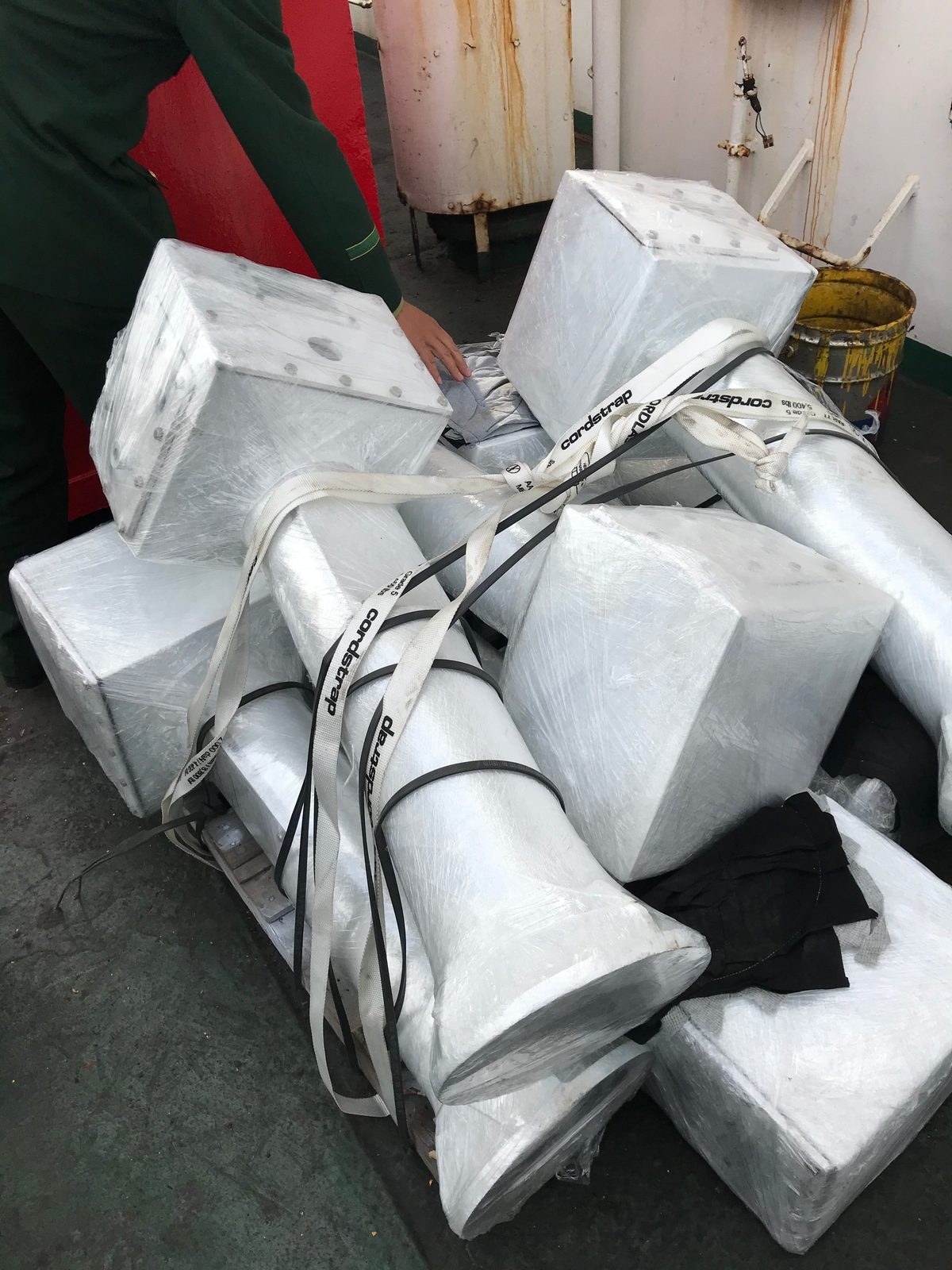 Wrapped metal components secured together on a vessel deck