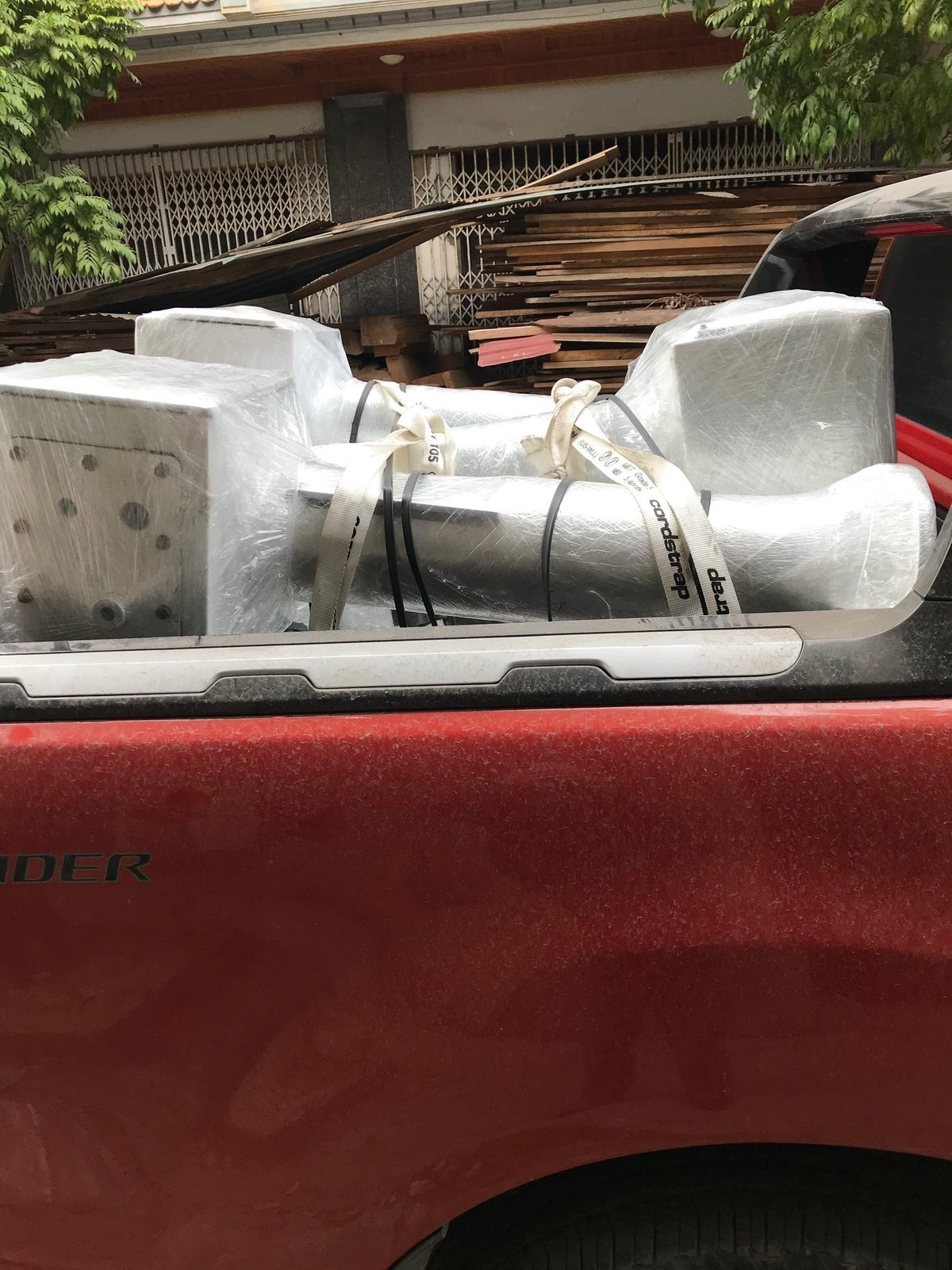 Wrapped metal components secured in a pickup truck
