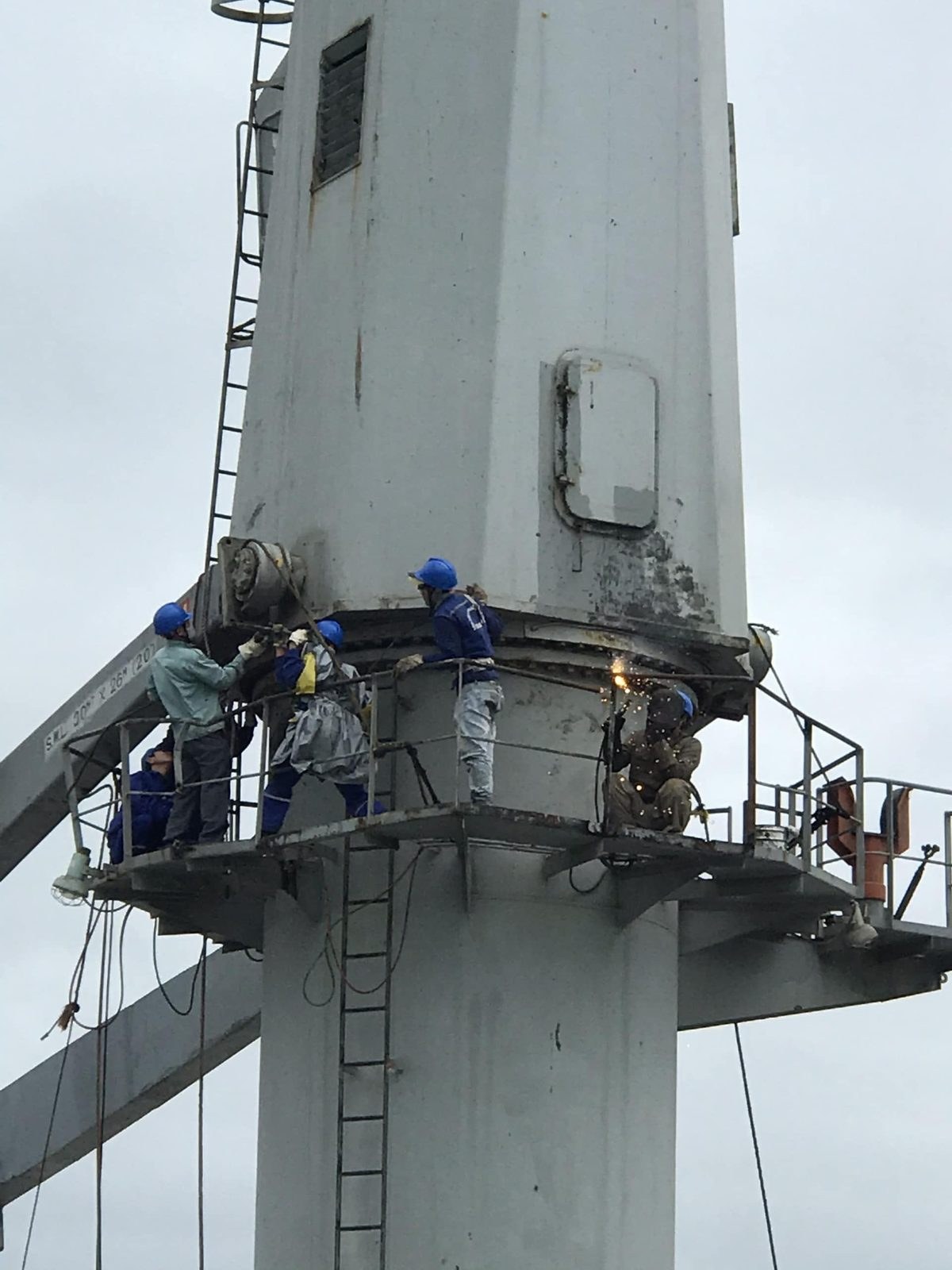 Technicians at the jib crane pedestal