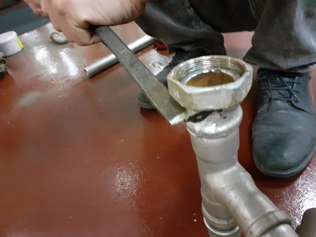 Fitting a pipe union on the engine room floor