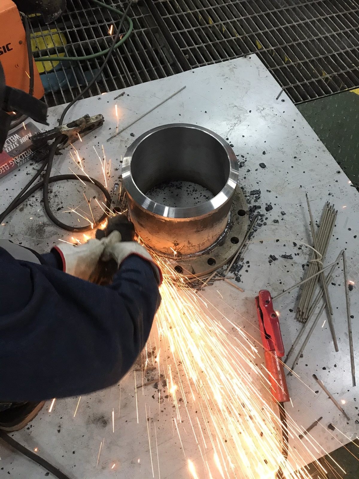 Grinding a scrubber overboard flange on deck