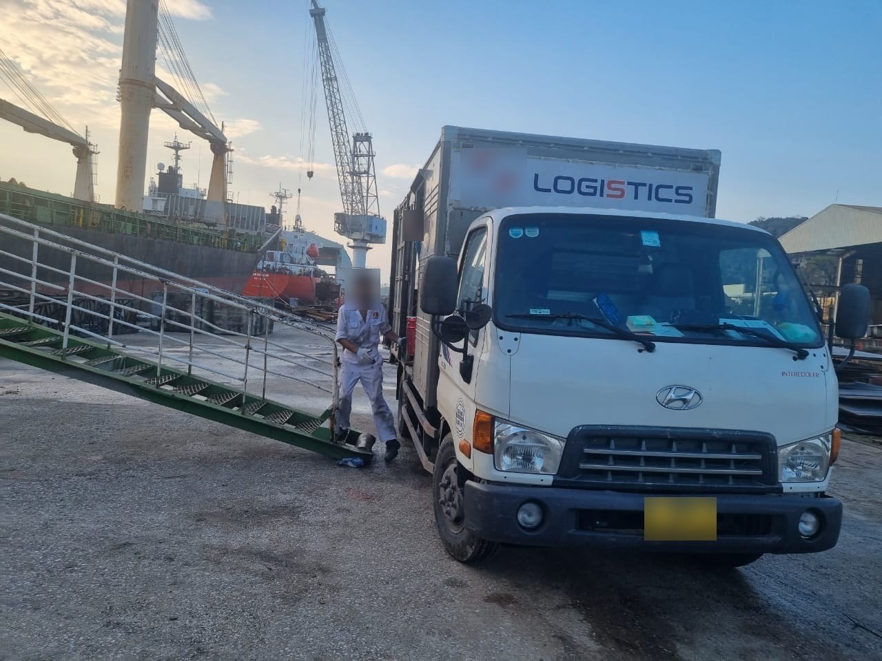 Stores truck alongside the ship's gangway for delivery.