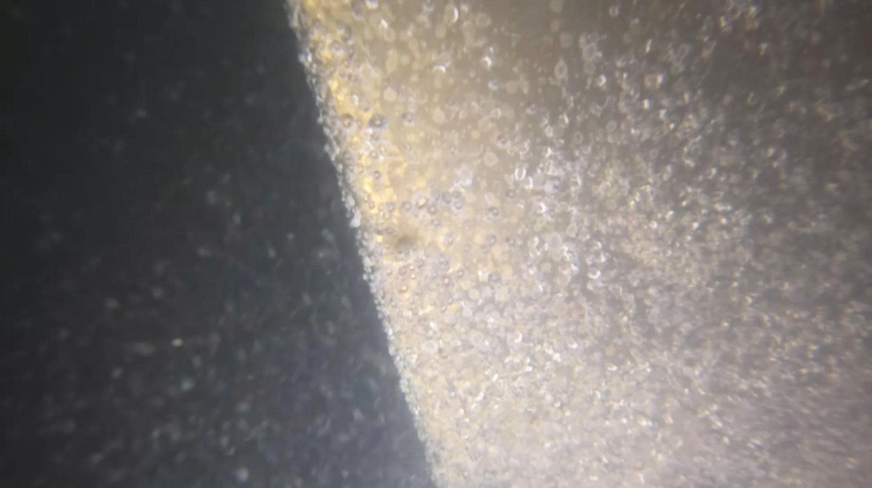 Close underwater view of a propeller blade surface