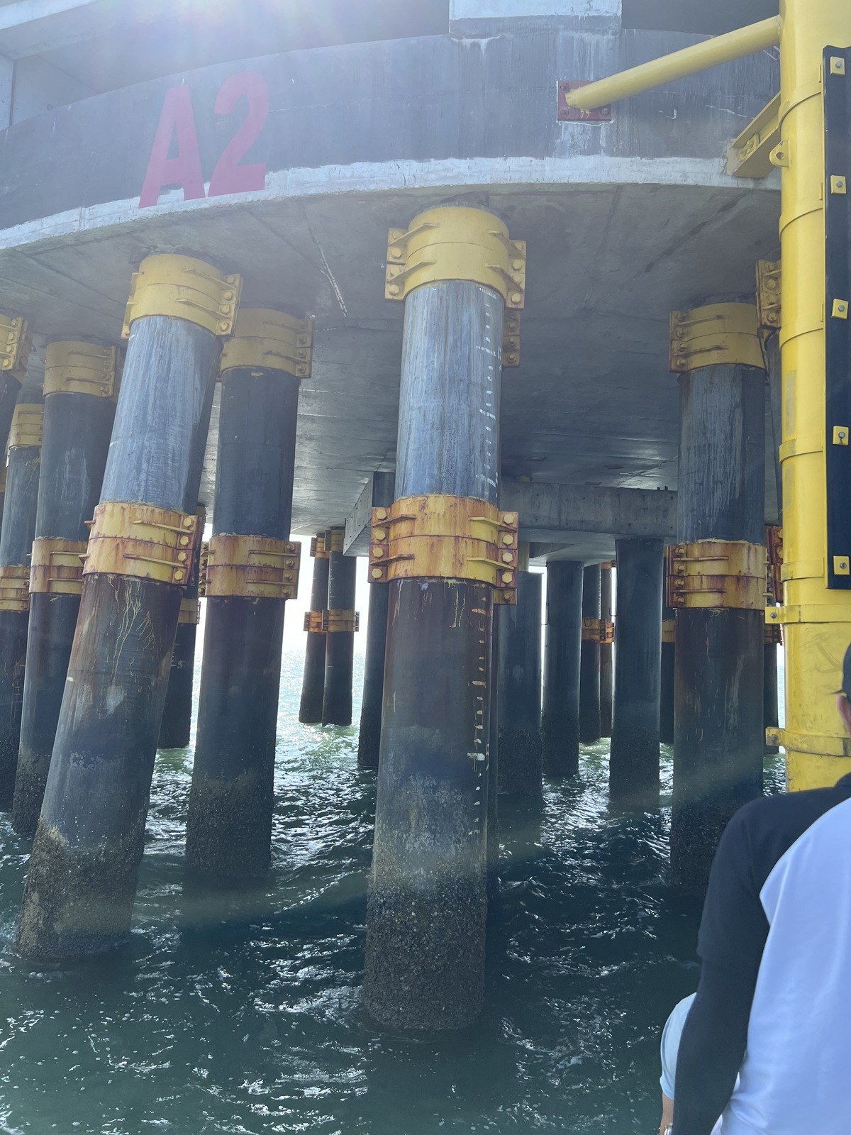 Wind turbine foundation piles and pile clamps at the waterline