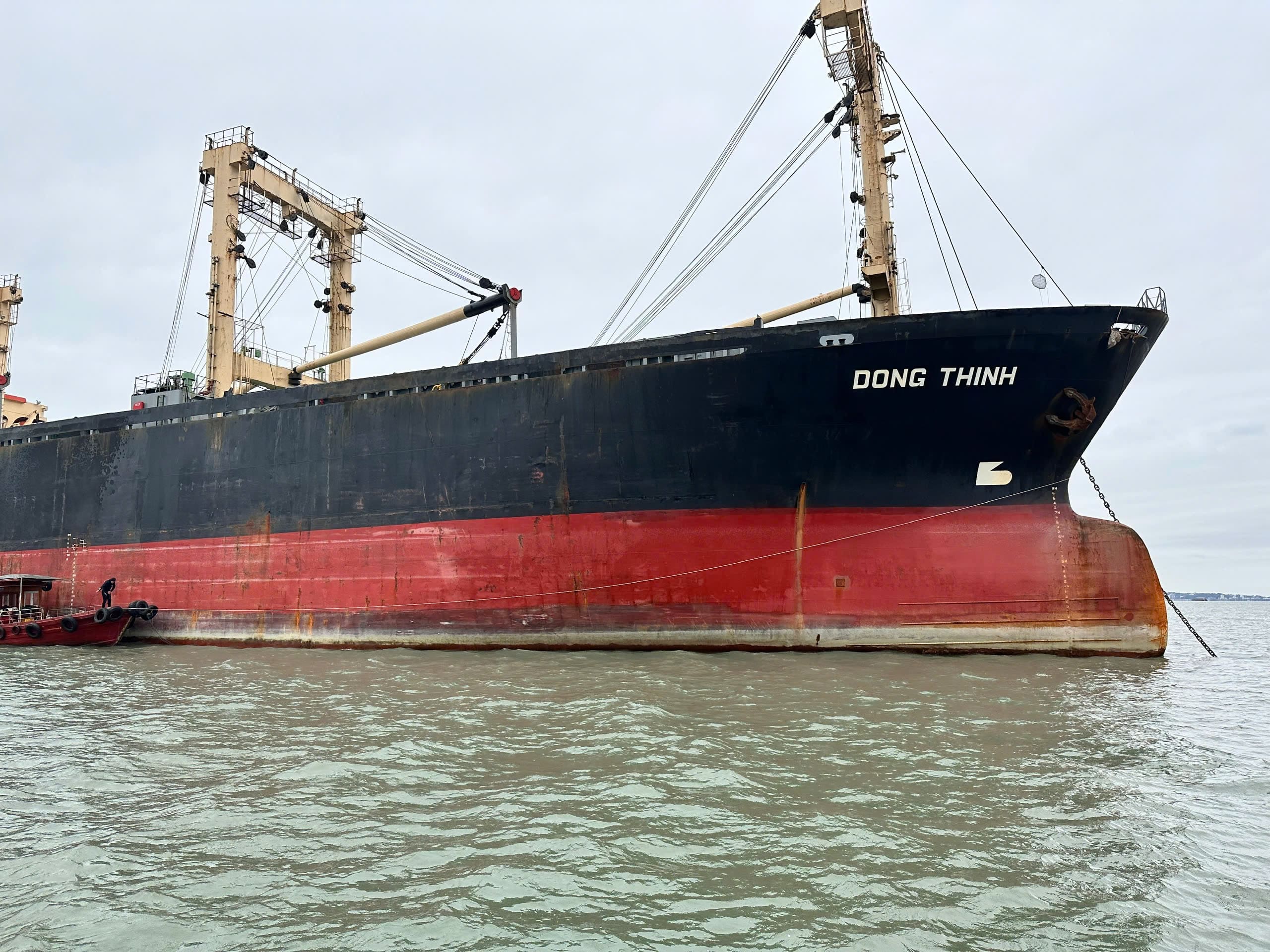 Sister ships Dong An and Dong Thinh alongside in Vietnam prior to paired delivery on 20 December 2024; derrick booms rigged for rice loading.
