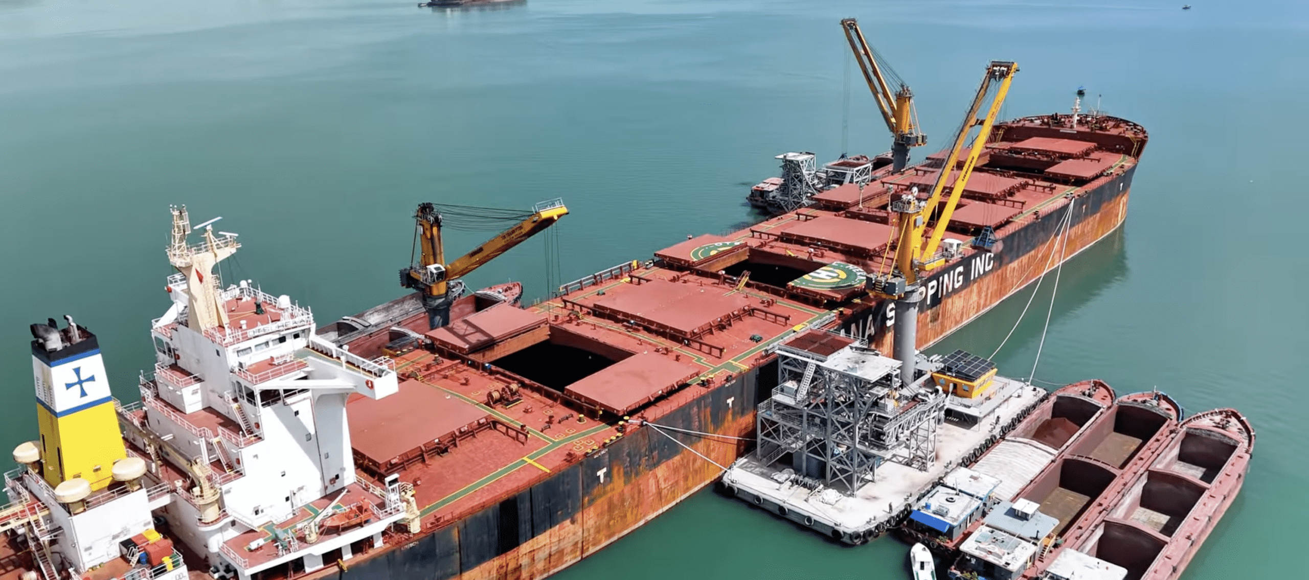 Floating crane discharging coal at anchorage Cam Pha of Vietnam