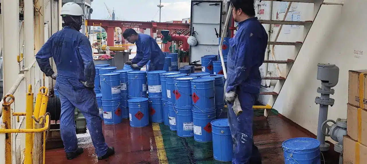 Coating drums transferred to a vessel at anchorage by workboat